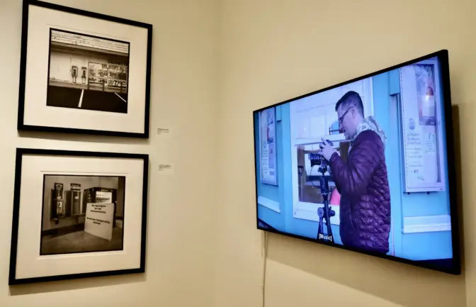 Part of the exhibit is a video, ”Felicific Calculus: Technology as a Social Marker of Race, Class, & Economics in Rochester, NY, 2021,” which documents Eric Kunsman’s efforts to photograph all 1,455 payphones in Rochester. (Emma Lee/WHYY)