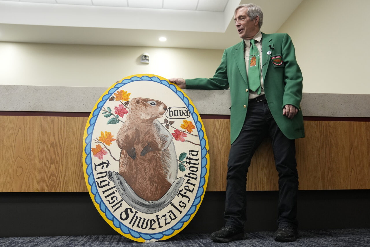 Kutztown University anthropology professor William W. Donner displays a Groundhog Lodge's sign during an interview in Kutztown, Pa., Monday, Jan. 29, 2024. These lodges began as a way to preserve and celebrate Pennsylvania Dutch culture and traditions. (AP Photo/Matt Rourke)