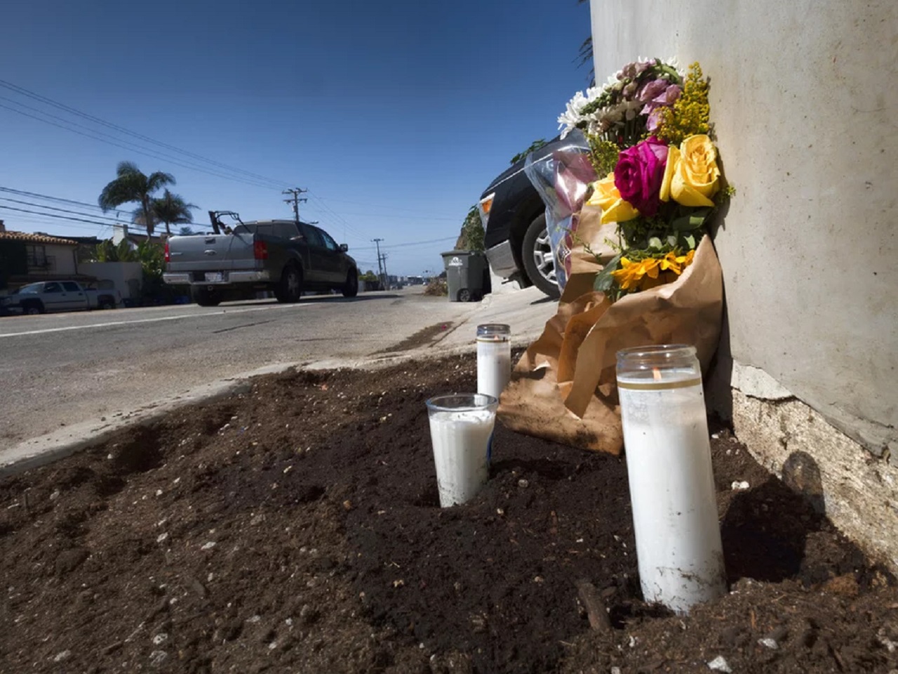 Candles and flowers on the side of the Pacific Coast Highway in Malibu, Calif., after a crash killed four college students in October 2023.
Richard Vogel/AP