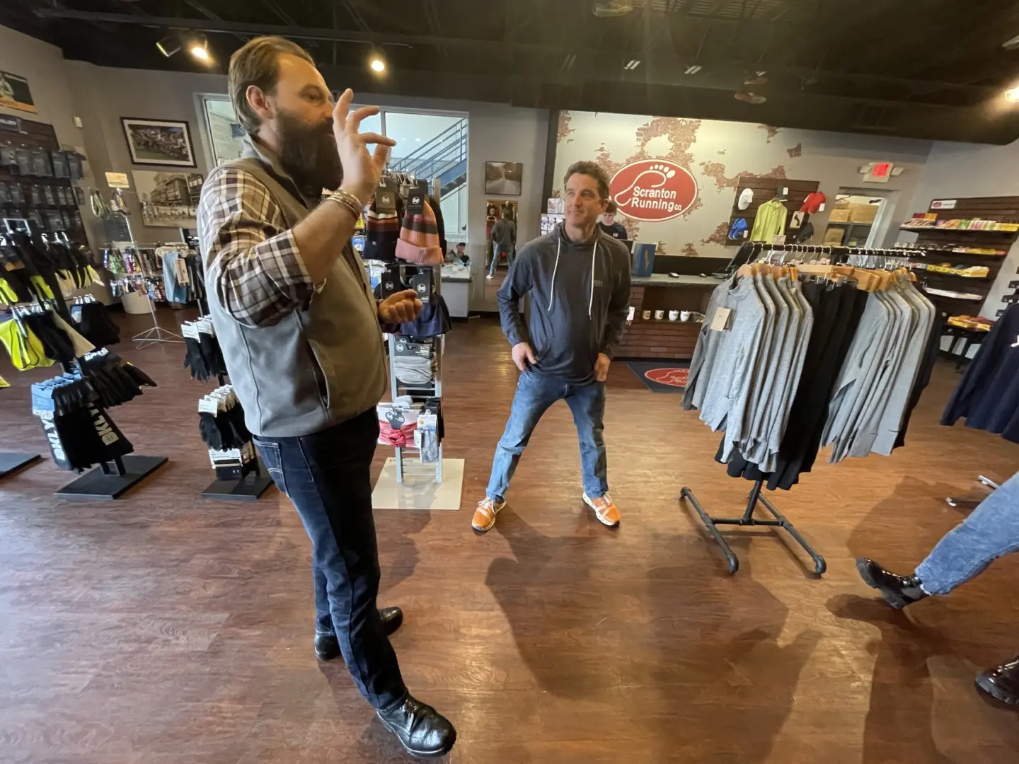 Pennsylvania's Director of Outdoor Recreation Nathan Reigner, Ph.D., left, chats with Matt Bryne, right, owner of the Scranton Running Company during a visit to some of Scranton's outdoor businesses.
