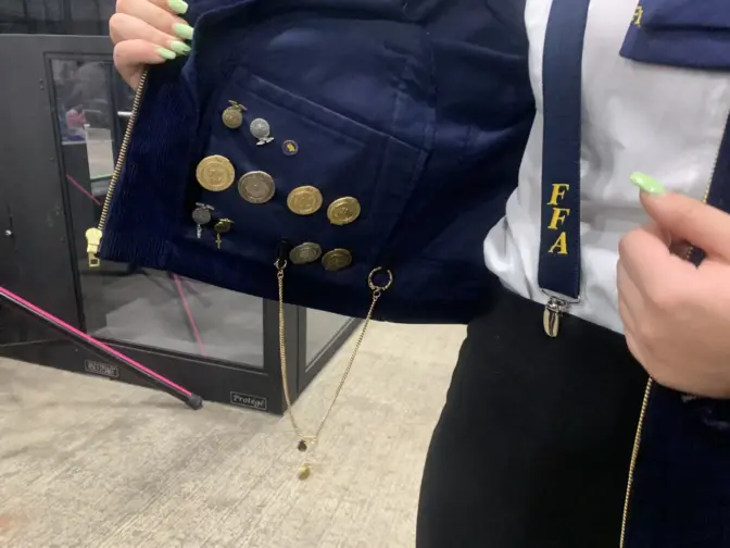 Senior Abigail Rosenberry from Big Spring FFA shows her badges she keeps in her jacket. FFA members only wear their three highest honors on the front of their jackets.