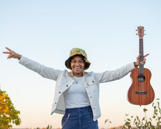 Country musician Sug Daniels poses with a guitar.