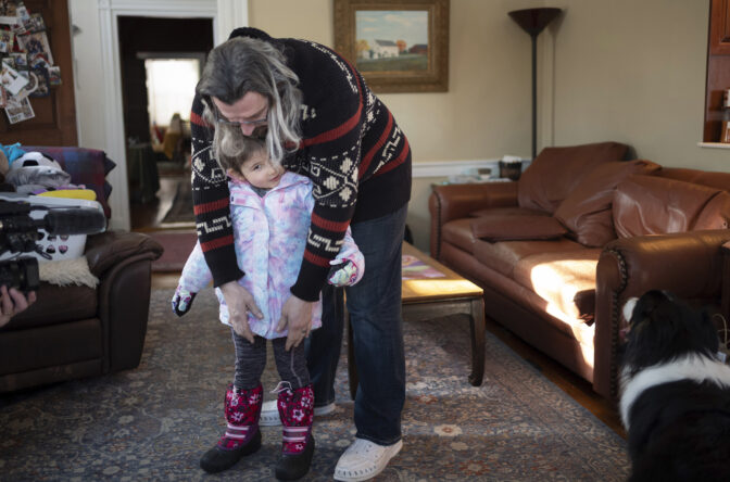 Curt Balsh gets his daughter ready for school in Hellertown, Penn. on Wednesday, Jan. 17, 2024. President Joe Biden is warning that Donald Trump will be a grave threat to American democracy if he wins re-election, but interviews with Pennsylvania voters again suggest it's not resonating. Balch, 44,  worked in the health care industry and is now a stay-at-home dad. He said the messaging by both sides is “pretty toxic” when they warn that the other is “a threat or a danger to the fundamentals of the country moving forward." (AP Photo/Laurence Kesterson)