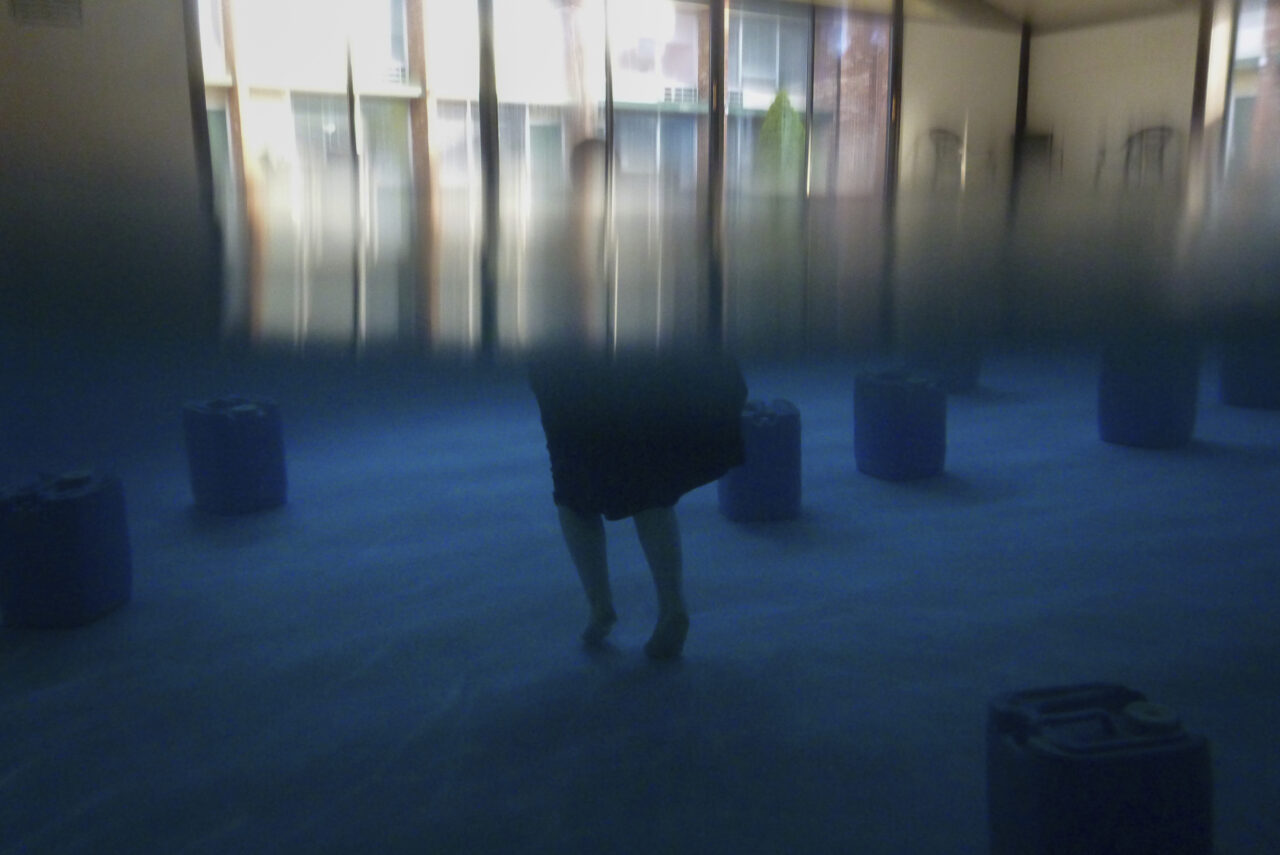 An Amish woman from Ohio moves among BioHealing generator canisters at Tesla Wellness Hotel and MedBed Center on Wednesday, Nov. 15, 2023, in Butler, Pa. The company claims the canisters exude “life force energy,” or biophotons. Testimonials from the company's patients speak to the device’s power to treat cancer, dementia, chronic pain and even broken bones. (AP Photo/Carolyn Kaster)