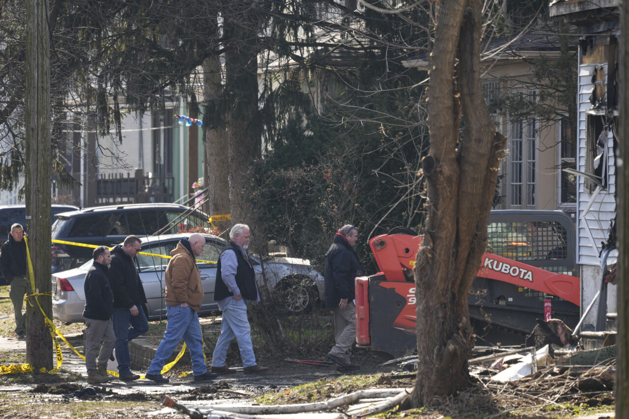 Investigators work at the scene where two police officers were injured while responding to reported standoff in East Lansdowne, Pa., Thursday, Feb. 8, 2024. (AP Photo/Matt Rourke)