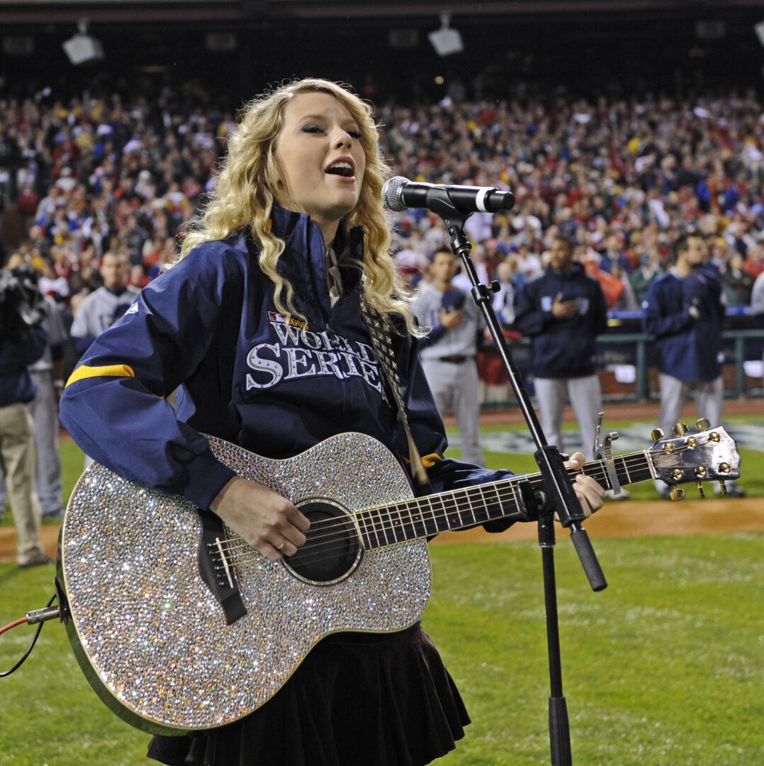 FILE - Singer Taylor Swift performs before Game 3 of the baseball World Series between the Tampa Bay Rays and Philadelphia Phillies Saturday, Oct. 25, 2008, in Philadelphia. Swift was tied to Francis Scott Key before Travis Kelce in her formative years, as the unsigned artist looked for any kind of break by belting out the national anthem in front of as many packed crowds as she could find. (AP Photo/Pool, John G. Mabanglo, File)