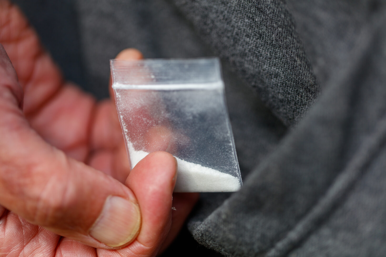 fentanyl opiate in plastic bag in hand close-up
