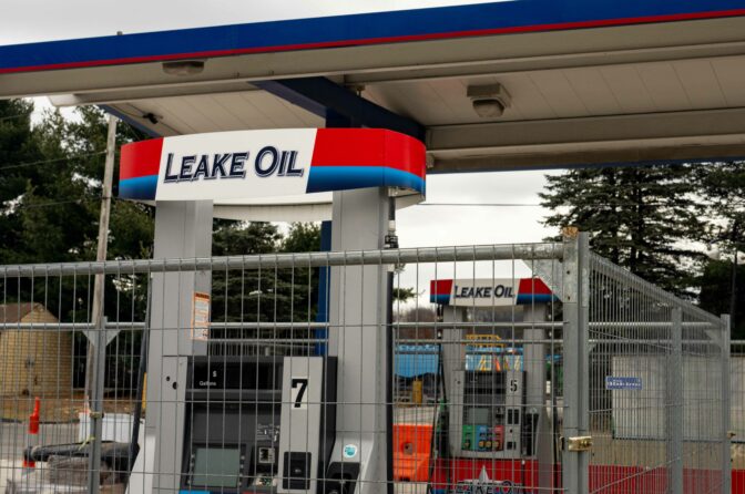 The pumps and convience store at Leake Oil are still fenced off one year after a train derailed from the tracks adjacent to the site. The derailment lead to environmental problems for the town and left Christina Dillworth, who used to work at the station's convience store, without a job. (Elizabeth Gillis/NPR)