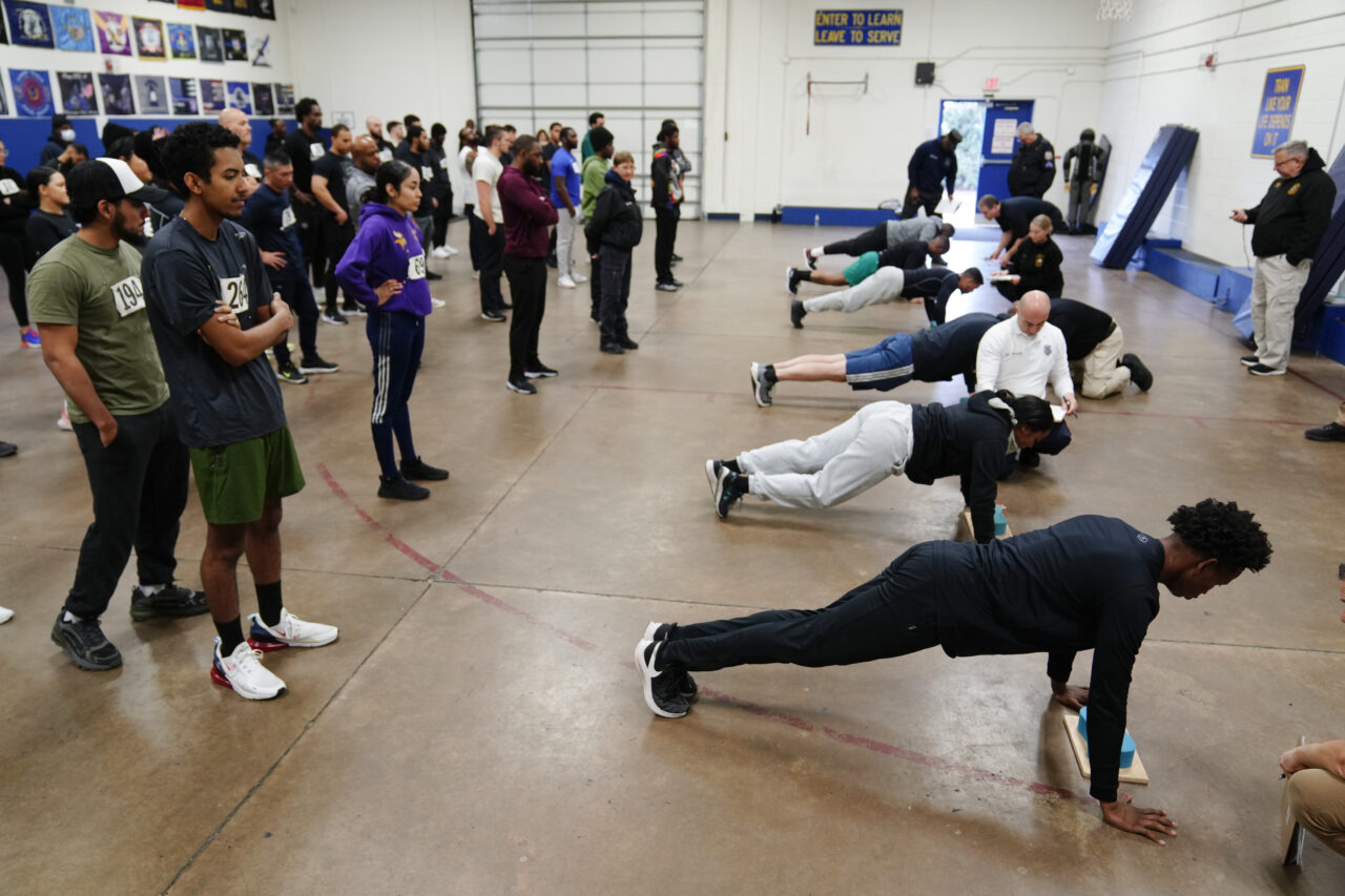 Philadelphia Police Academy staff count push ups during applicants' physical fitness entry exam in Philadelphia, Saturday, Feb. 24, 2024. The city has moved to lower requirements for the entry physical exam at its police academy as part of a broader effort nationally to reevaluate policies that keep law enforcement applicants out of the job pool amid a hiring crisis. (AP Photo/Matt Rourke)