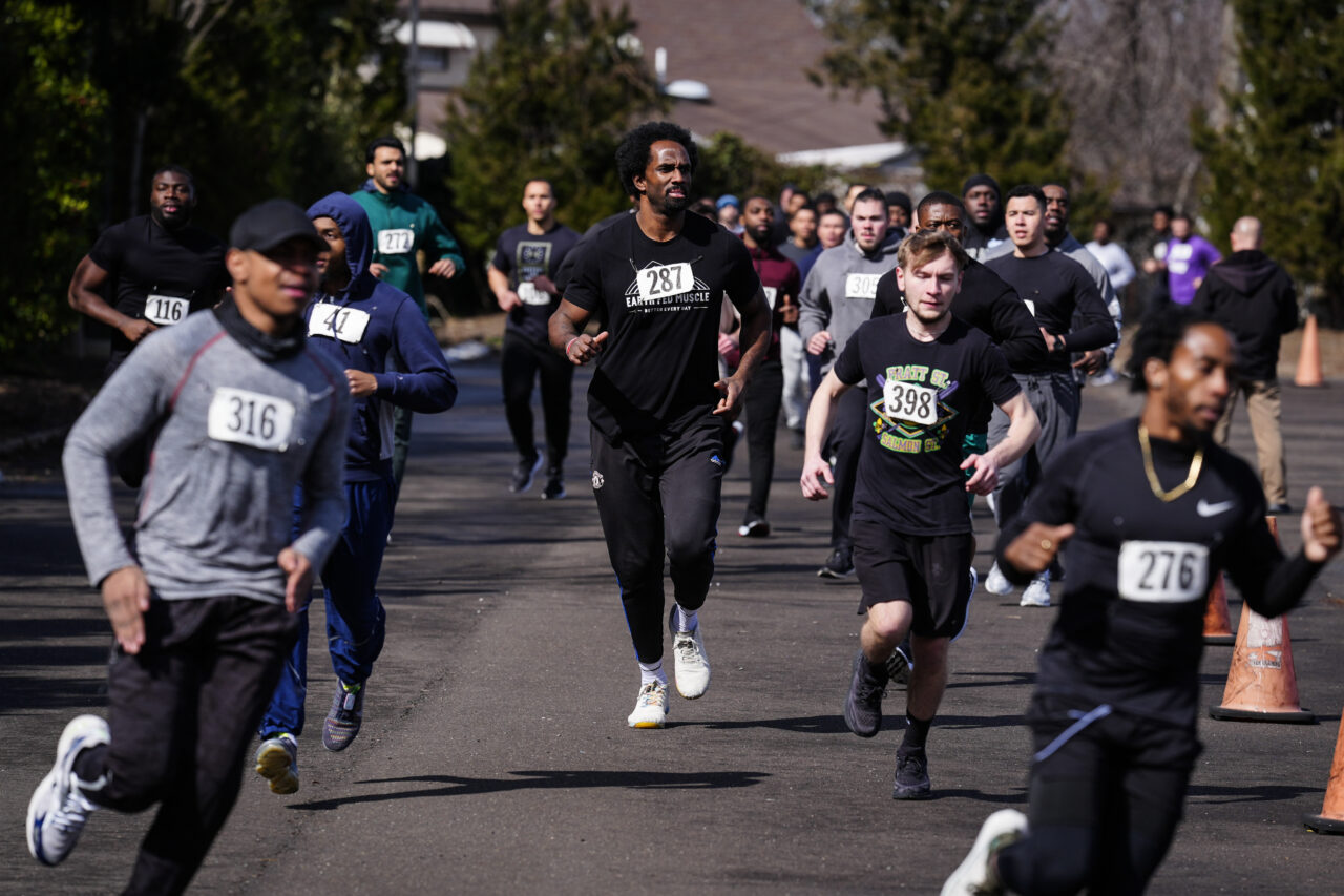 Philadelphia Police Academy applicant Curtis Cothran, center, takes part in the 1.5 mile run as part the physical fitness entry exam in Philadelphia, Saturday, Feb. 24, 2024. The city has moved to lower requirements for the entry physical exam at its police academy as part of a broader effort nationally to reevaluate policies that keep law enforcement applicants out of the job pool amid a hiring crisis. (AP Photo/Matt Rourke)