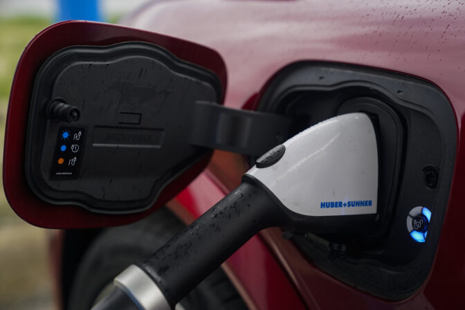 A 2023 Ford Mustang Mach-E charges, Friday, March 8, 2024, at an electric vehicle charging station in London, Ohio. The charging ports are a key part of President Joe Biden’s effort to encourage drivers to move away from gasoline-powered cars and trucks that contribute to global warming. (AP Photo/Joshua A. Bickel)