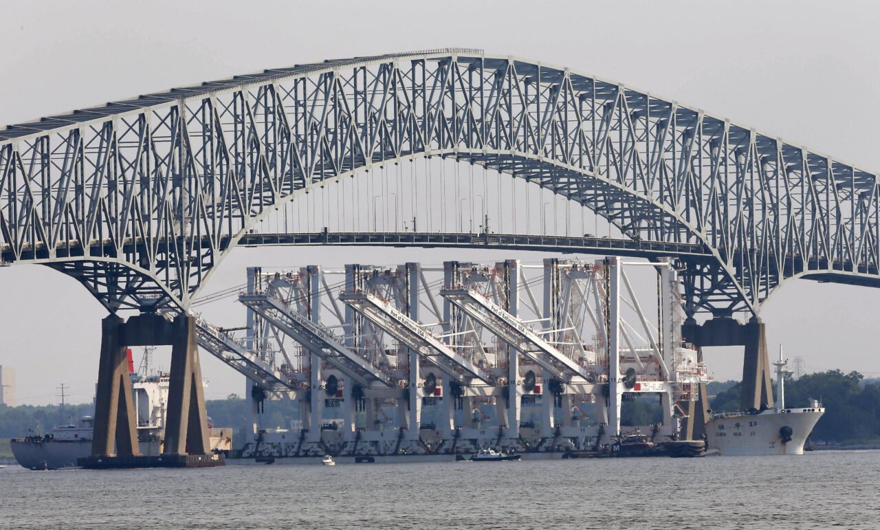 FILE - The vessel Zhen Hua 13, carrying four giant shipping cranes for delivery and installation at the Port of Baltimore, passes under the Francis Scott Key Bridge in Baltimore, Wednesday, June 20, 2012. A portion of the Francis Scott Key Bridge in Baltimore collapsed after a large boat collided with it early Tuesday, March 26, 2024 in the morning, and multiple vehicles fell into the water. Authorities were trying to rescue at least seven people. (AP Photo/Patrick Semansky, File)