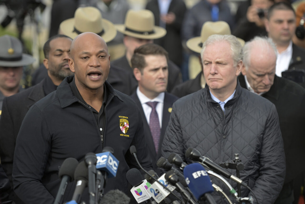 Maryland Gov. Wes Moore, left, speaks during a news conference as Sen. Chris Van Hollen (D-MD) looks on near the scene where a container ship collided with a support on the Francis Scott Key Bridge, Tuesday, March 26, 2024 in Baltimore. The major bridge in Baltimore snapped and collapsed after a container ship rammed into it early Tuesday, and several vehicles fell into the river below. Rescuers were searching for multiple people in the water. (AP Photo/Steve Ruark)