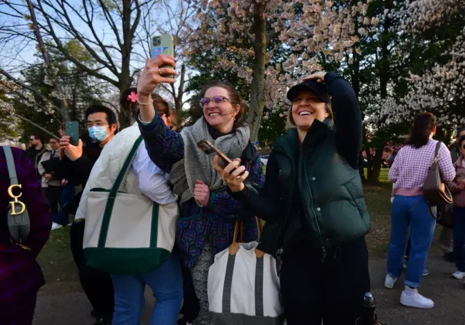 People photograph the cherry blossoms as they reached peak bloom early at the Tidal Basin.Carol Guzy/Carol Guzy for NPR
