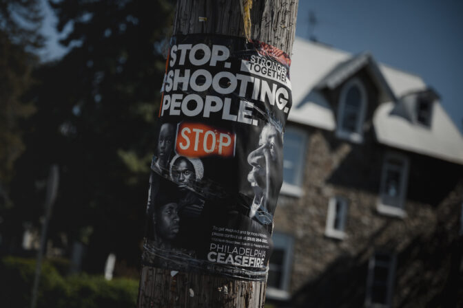 A “Stop. Shooting. People.” Poster by Philadelphia Ceasefire is posted in East Germantown in Philadelphia, PA, on Monday March 25 2024.