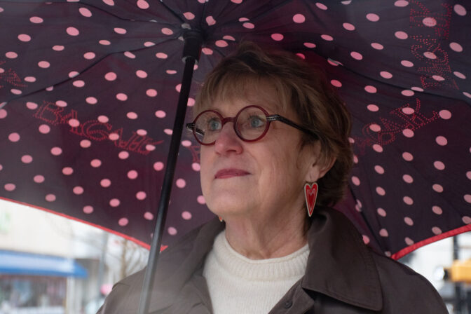 Lancaster Public Library Executive Director Lissa Holland stands for a portrait in front of police tape in the 100 block of Queen Street in Lancaster City on Saturday, March. 23, 2024. The Drag Queen Story Hour at the Lancaster Public Library was canceled after police responded to a suspicious package.