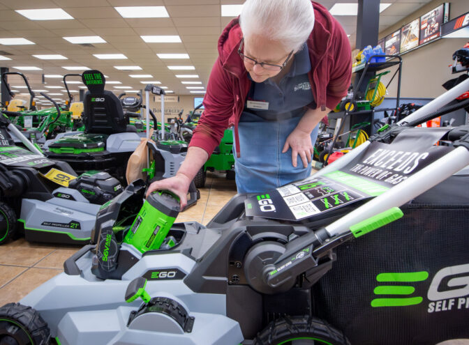 Esther Hess, Power Equipment Manager, shows the battery on an EGO 21” self-propelled mower Inside Bombergers store 555 Furnace Hills Pike in Warwick Township on Thursday, April 25, 2024.
