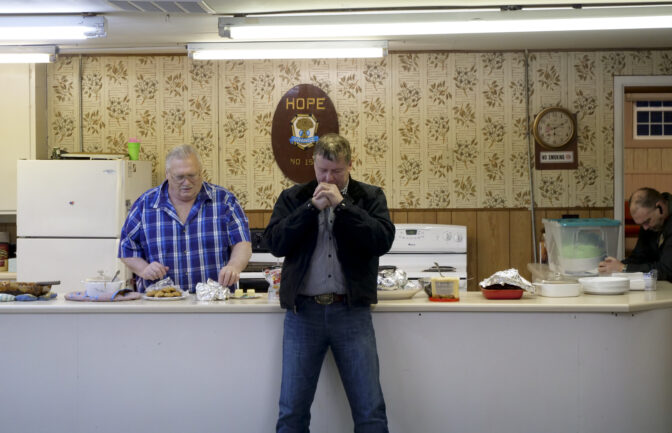 Mike Porter Jr. grange master at Hope Grange #155 in Winlock, Washington says a prayer before a potluck dinner on March 5, 2024. (Jeremy Long - WITF)