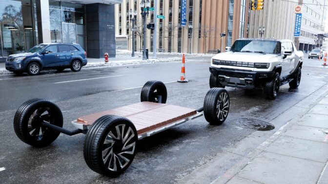 A battery pack and GM's new Hummer EV stand outside an event where General Motors announced an investment of more than $7 billion in four Michigan manufacturing sites on January 25, 2022 in Lansing, Michigan. - General Motors will create 4,000 new jobs and retaining 1,000, and significantly increasing battery cell and electric truck manufacturing capacity. This is the single largest investment announcement in GM history. The investment includes construction of a new Ultium Cells battery cell plant in Lansing and the conversion of GM's assembly plant in Orion Township, Michigan for production of the Chevrolet Silverado EV and the electric GMC Sierra, GM's second assembly plant scheduled to build full-size electric pickups. (Photo by JEFF KOWALSKY / AFP) (Photo by JEFF KOWALSKY/AFP via Getty Images)