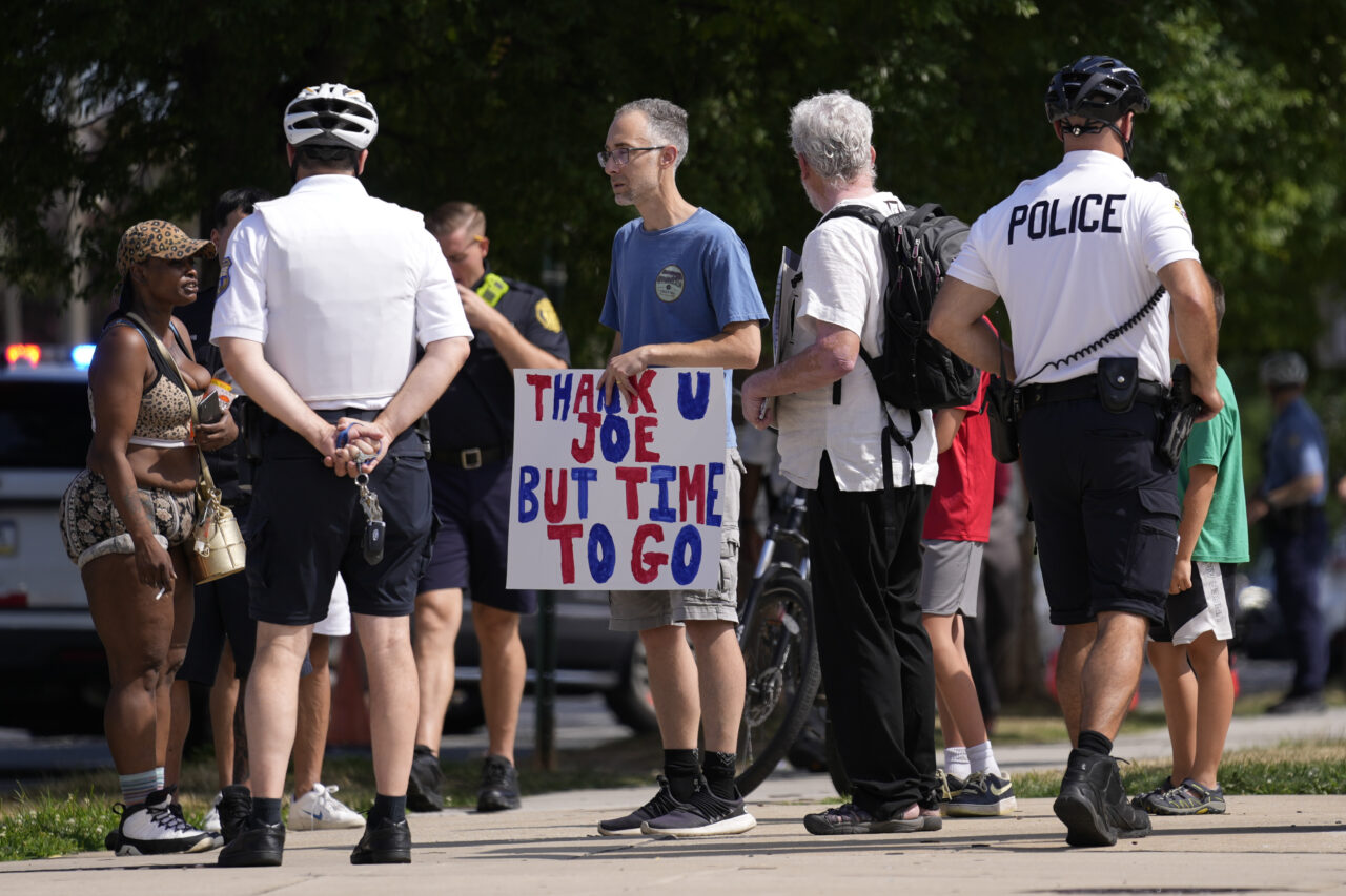 A protester holds a sign ahead of President Joe Biden's visit to Mt. Airy Church of God in Christ, Sunday, July 7, 2024, in Philadelphia. (AP Photo/Matt Rourke)