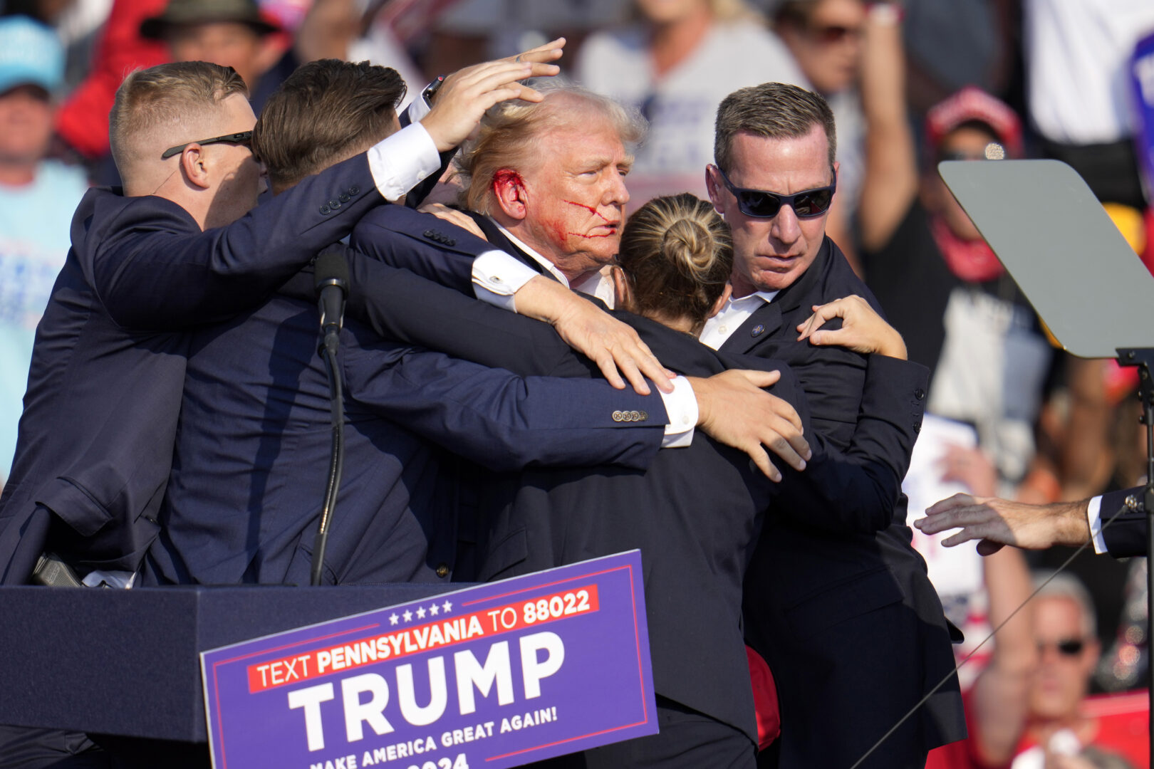 Republican presidential candidate former President Donald Trump is helped off the stage at a campaign event in Butler, Pa., on Saturday, July 13, 2024. 