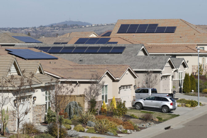 In this photo taken Wednesday Feb. 12, 2020, are solar panels on rooftops of a housing development in Folsom, Calif. When California finalized the nation's first sweeping rooftop solar mandate for new construction last year, advocates pictured a utopia of all homes being built with solar panels, turning the clunky panels into the new norm to help the state achieve state carbon neutrality. But those images of self-sustaining abodes may be dashed, supporters warn, if an electric utility in Sacramento wins a widely watched case on Thursday, Feb. 20, deciding how the new solar mandate will be interpreted. (AP Photo/Rich Pedroncelli)