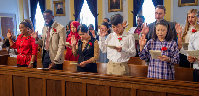 Candidates for citizenship say the oath of allegiance during naturalization ceremonies at the Lancaster County Courthouse on Friday, Sept. 13, 2024. 25 candidates for citizenship, took the oath of allegiance and became United States citizens during the ceremony. Political disinformation about immigrants is often used in conjunction with false stories about ineligible people voting, according to elections expert Alice Clapman.
