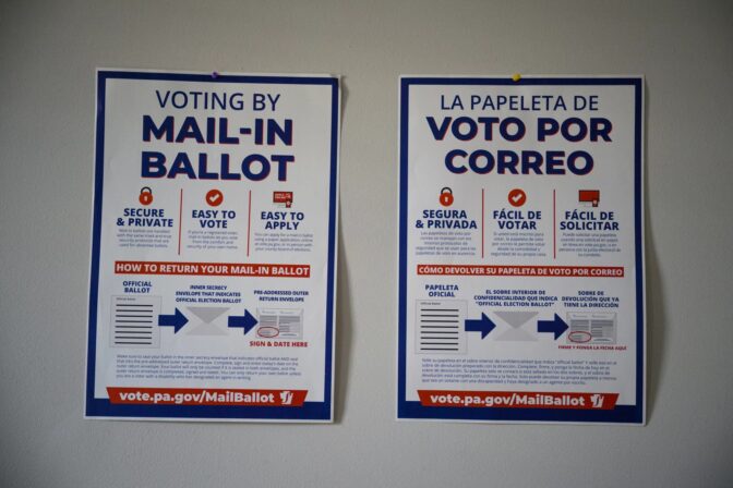 Signs about mail voting are pinned to a wall in the offices of civic engagement organization Ceiba in the Norris Square neighborhood of Philadelphia on Sept. 20.Kriston Jae Bethel for NPR