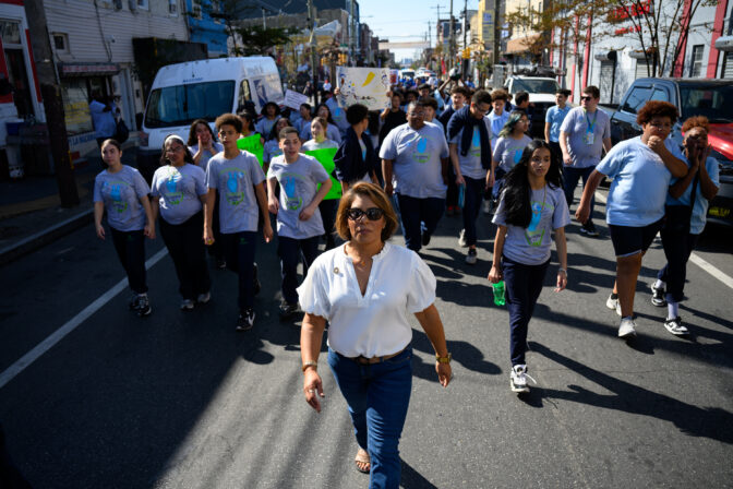 Councilwoman Quetcy Lozada, who leads Latinas for Kamala in Philadelphia, walks with students during a gun violence march on Friday, September 20, 2024. CREDIT: Kriston Jae Bethel for NPR