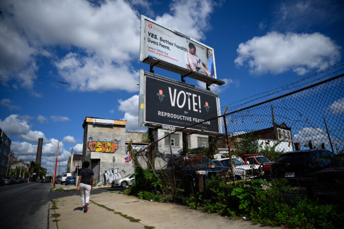 A billboard reading, "Vote! For Reproductive Freedom," sits behind an autobody shop in Philadelphia on Friday, September 20, 2024. CREDIT: Kriston Jae Bethel for NPR