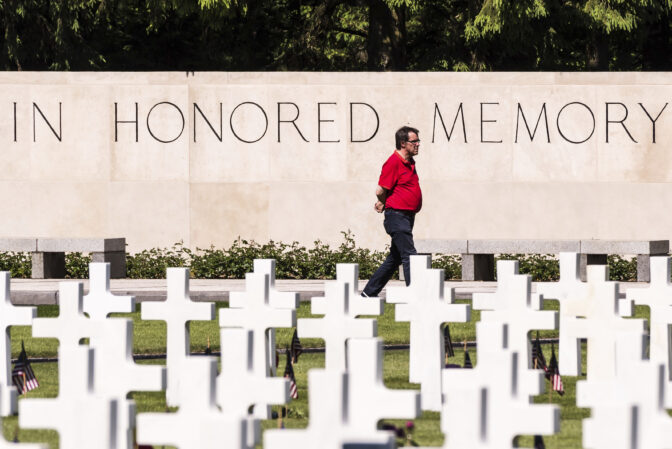 A man walks between the graves at the Henri-Chapelle American Cemetery and Memorial during the annual memorial day ceremony, in Plombieres, Belgium on Saturday May. 27, 2017.