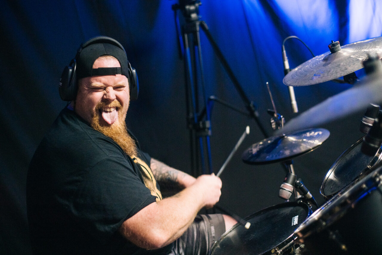 Paul Cochran at the drums sticking his tongue out.