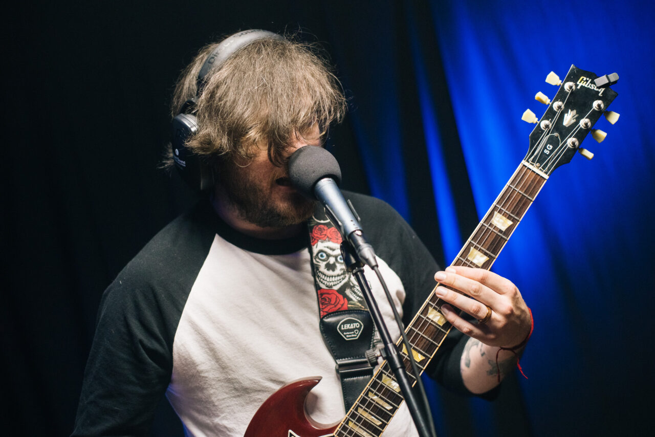 Albert Halterman playing guitar and singing.