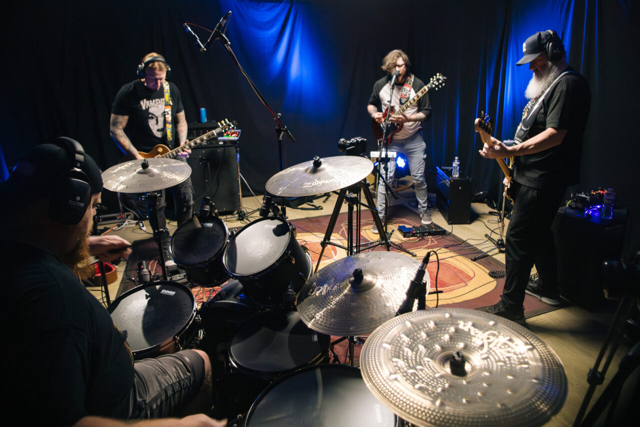 The full band in the studio performing