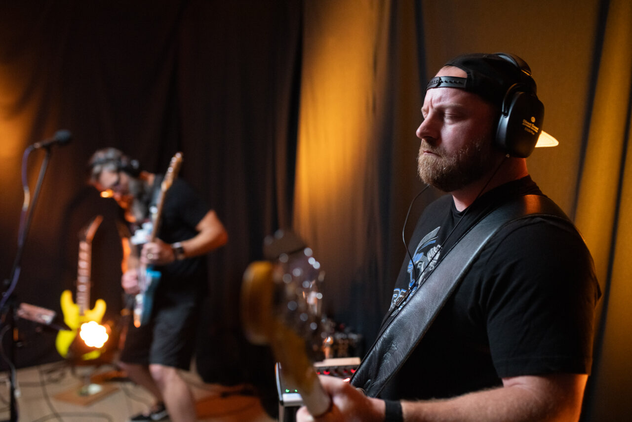 Andy Cornman and Mark Thompson playing guitar.