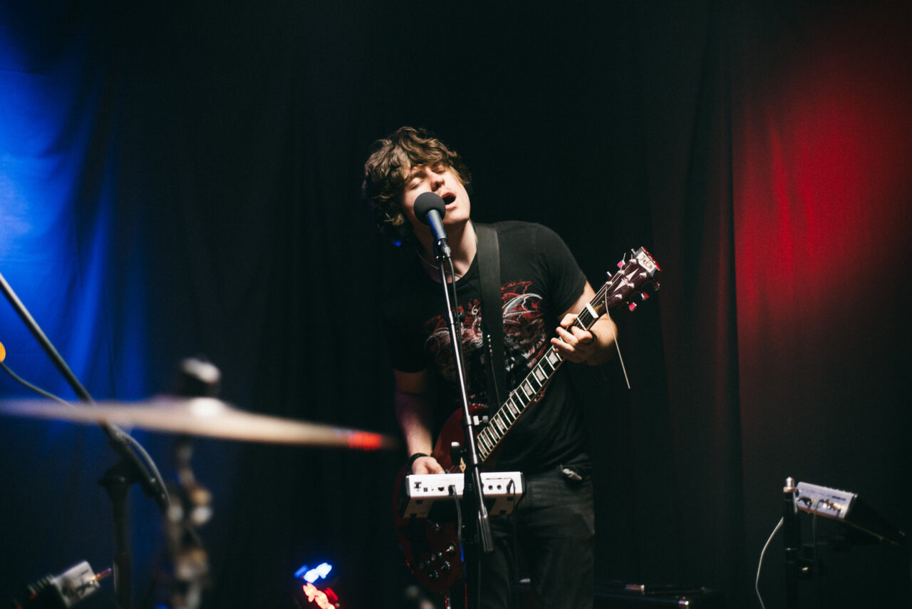 A singer/guitarist singing