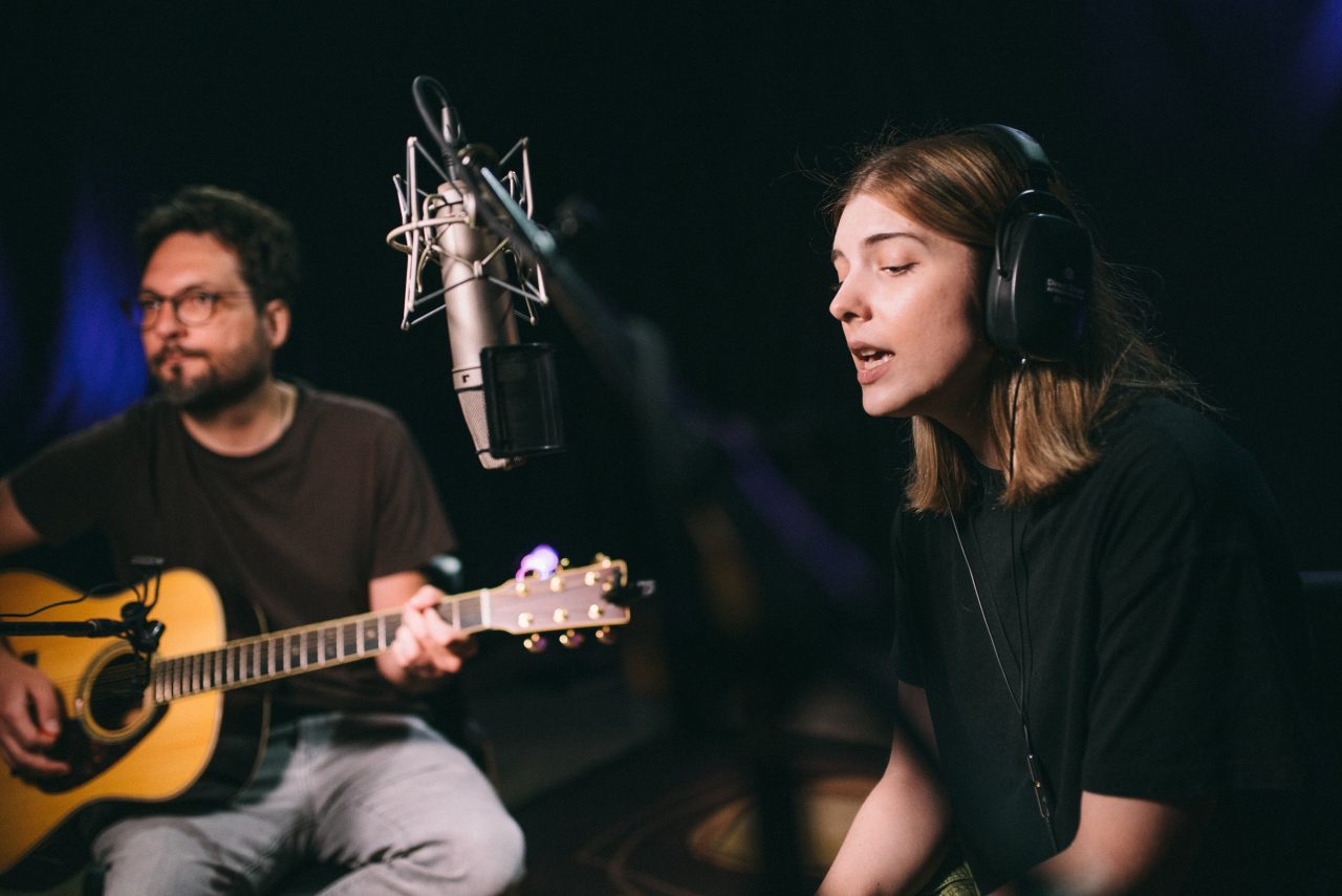 An image of Olivia Elizabeth Basar and guitarist Tyler Adkins performing.