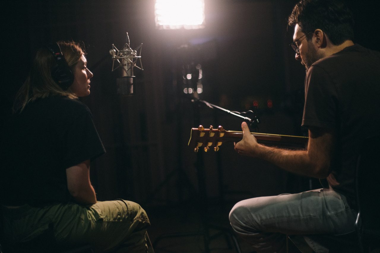 An image of Olivia Elizabeth Basar and guitarist Tyler Adkins performing.