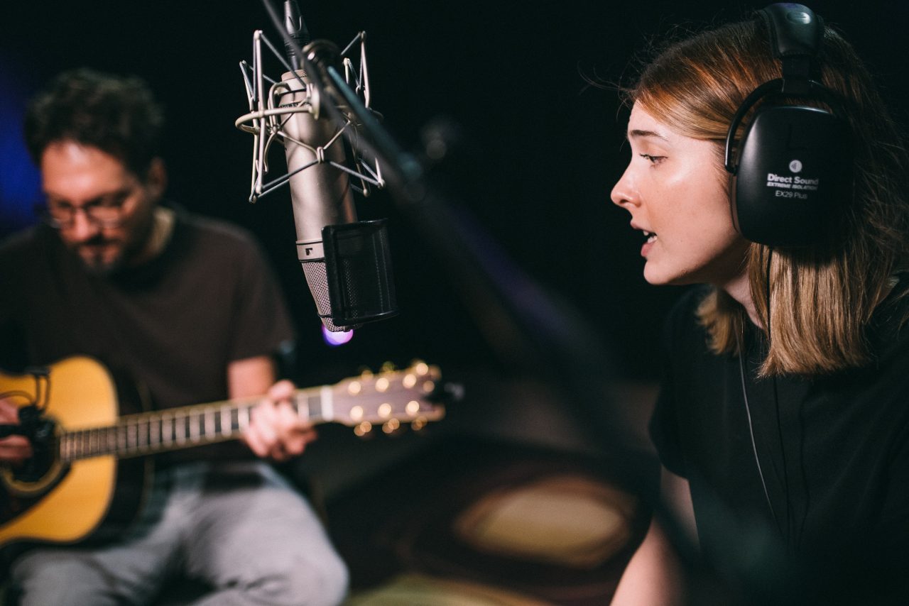 An image of Olivia Elizabeth Basar and guitarist Tyler Adkins performing.