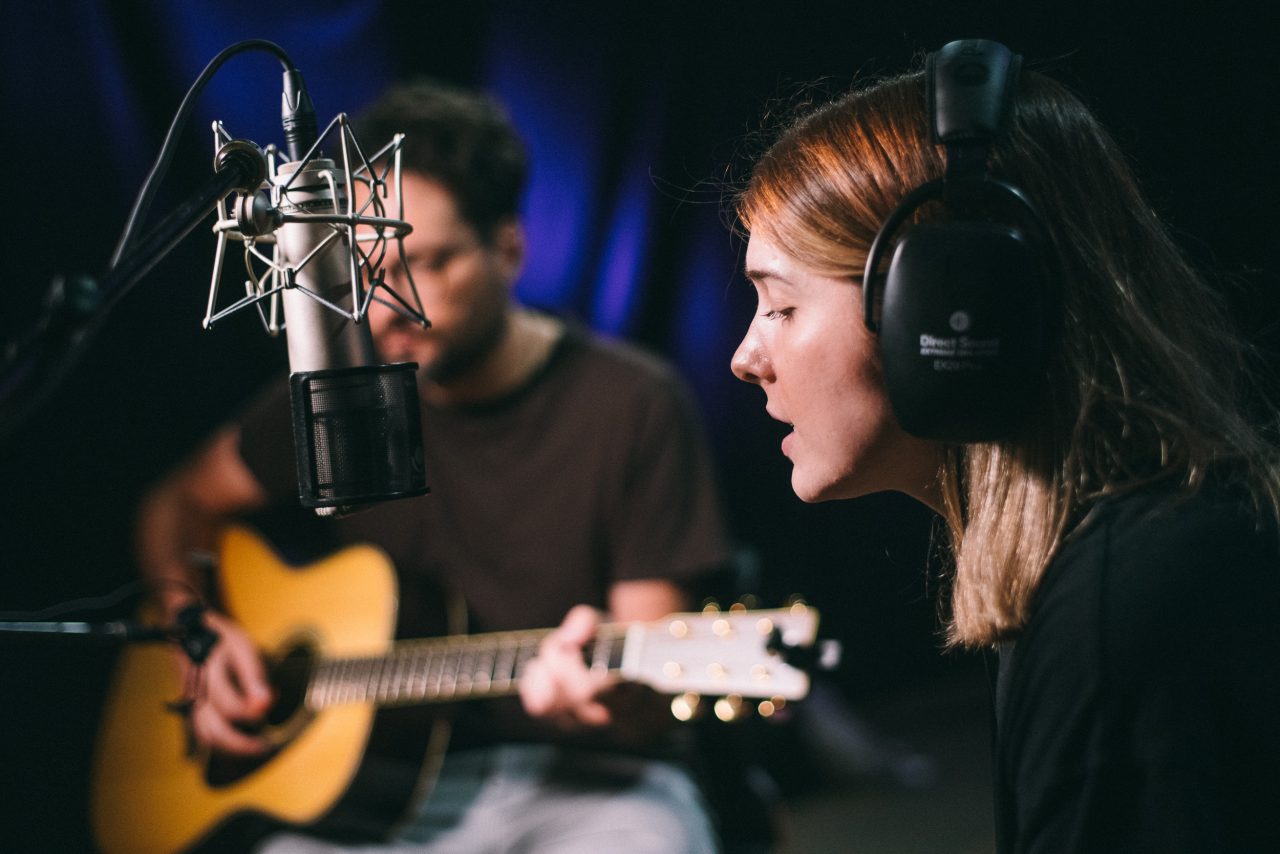 An image of Olivia Elizabeth Basar and guitarist Tyler Adkins performing.
