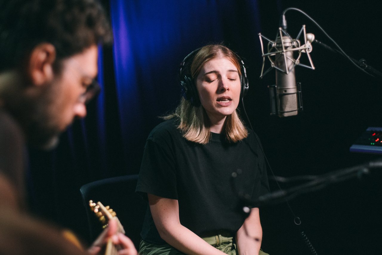 An image of Olivia Elizabeth Basar and guitarist Tyler Adkins performing.