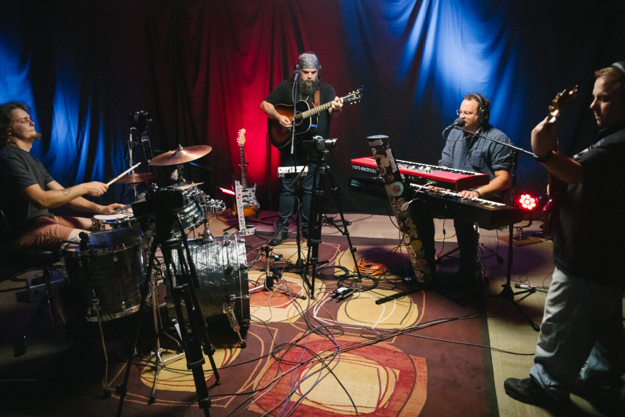 Dr Nyce and his band performing in a studio.