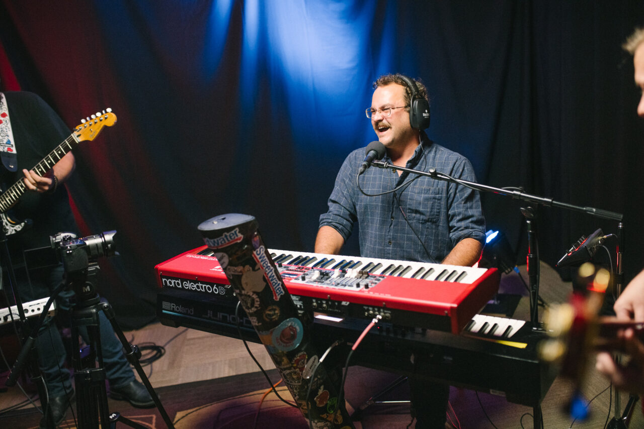 Zach Nyce playing keyboard and singing.