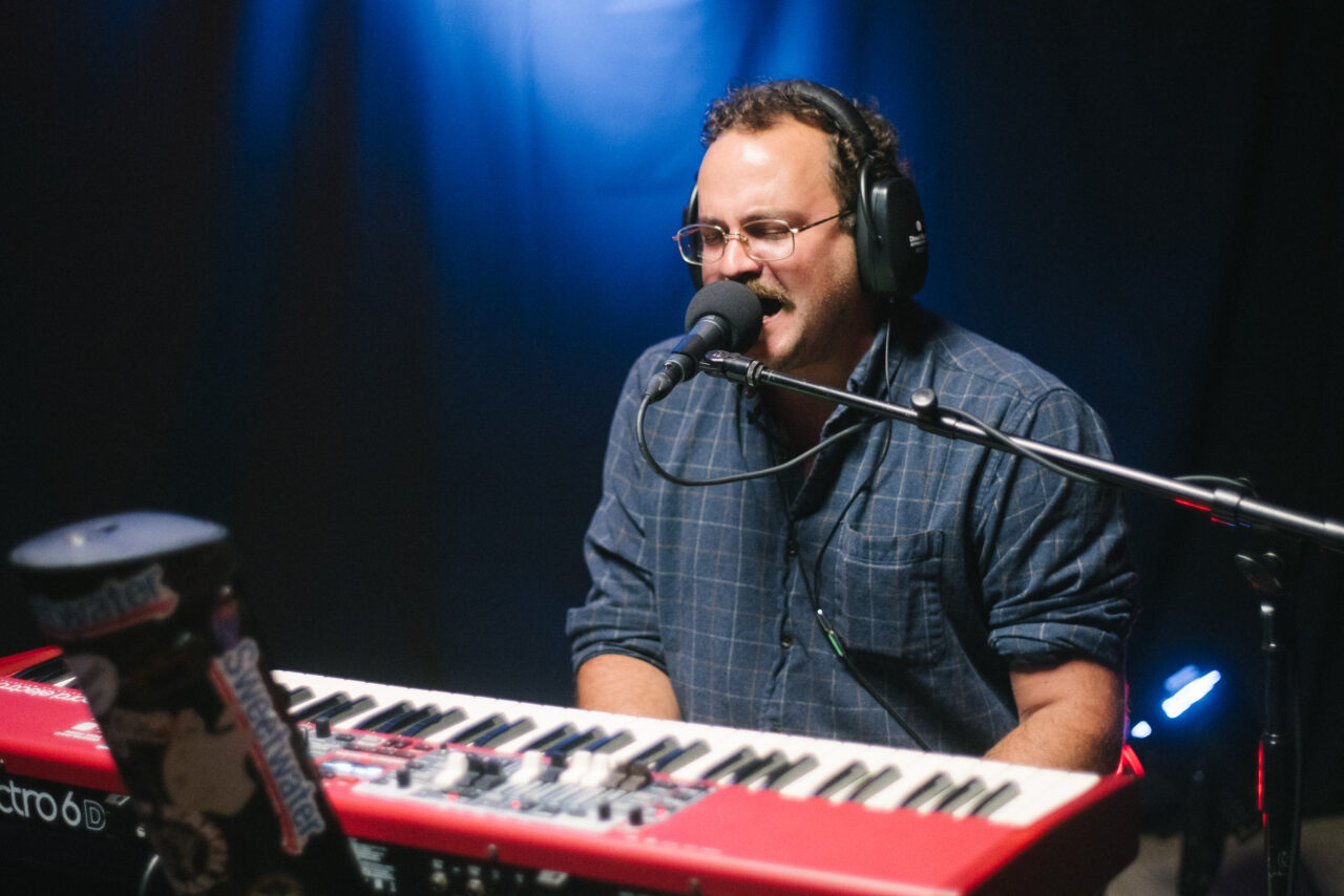 Zach Nyce singing and playing keyboard.