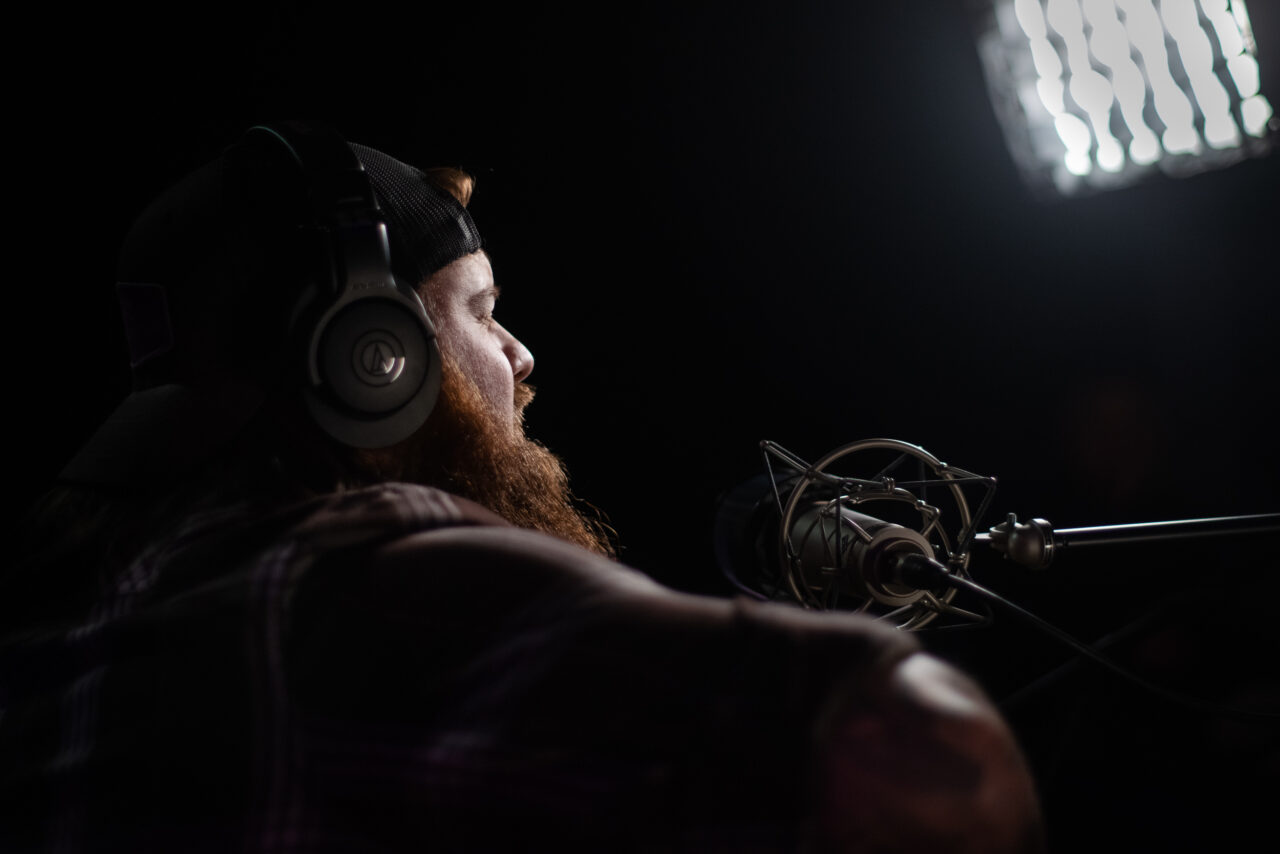 Jake Mach singing and playing guitar.