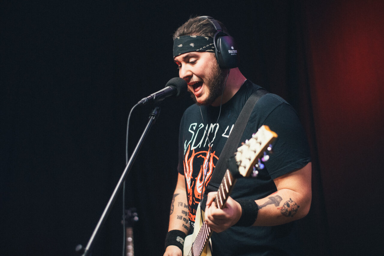 Jake Sholl playing guitar.