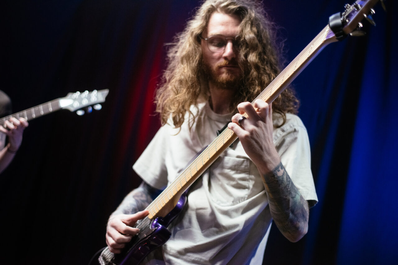 Guitarist in Making A Mockery playing guitar.