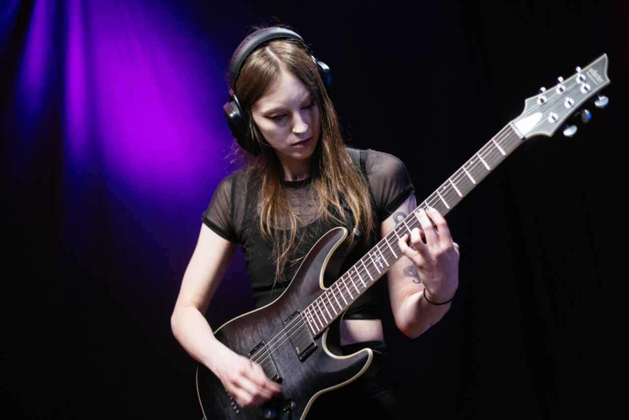 Guitarist in Making A Mockery playing guitar.