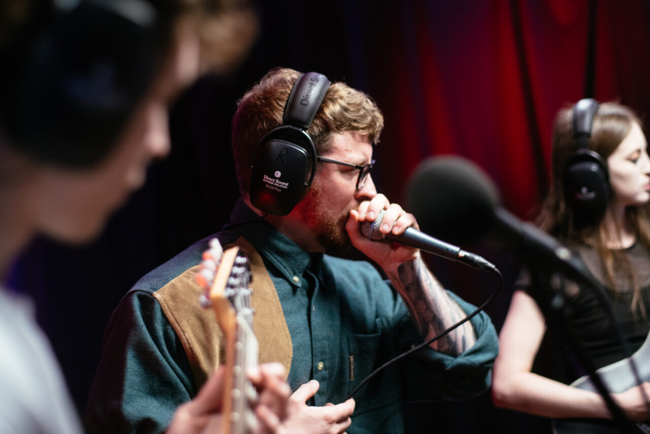 Lead singer of Making A Mockery singing into microphone.