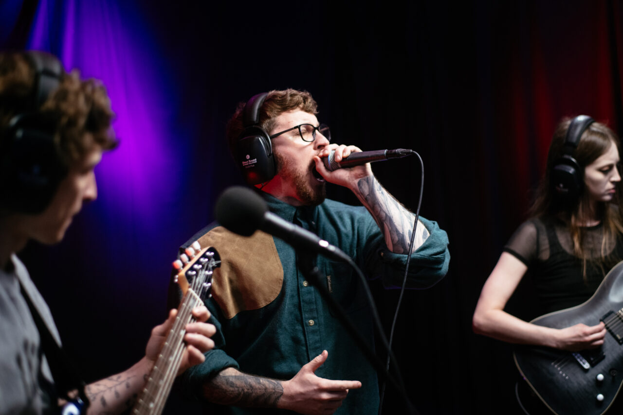 Lead singer of Making A Mockery singing into microphone.